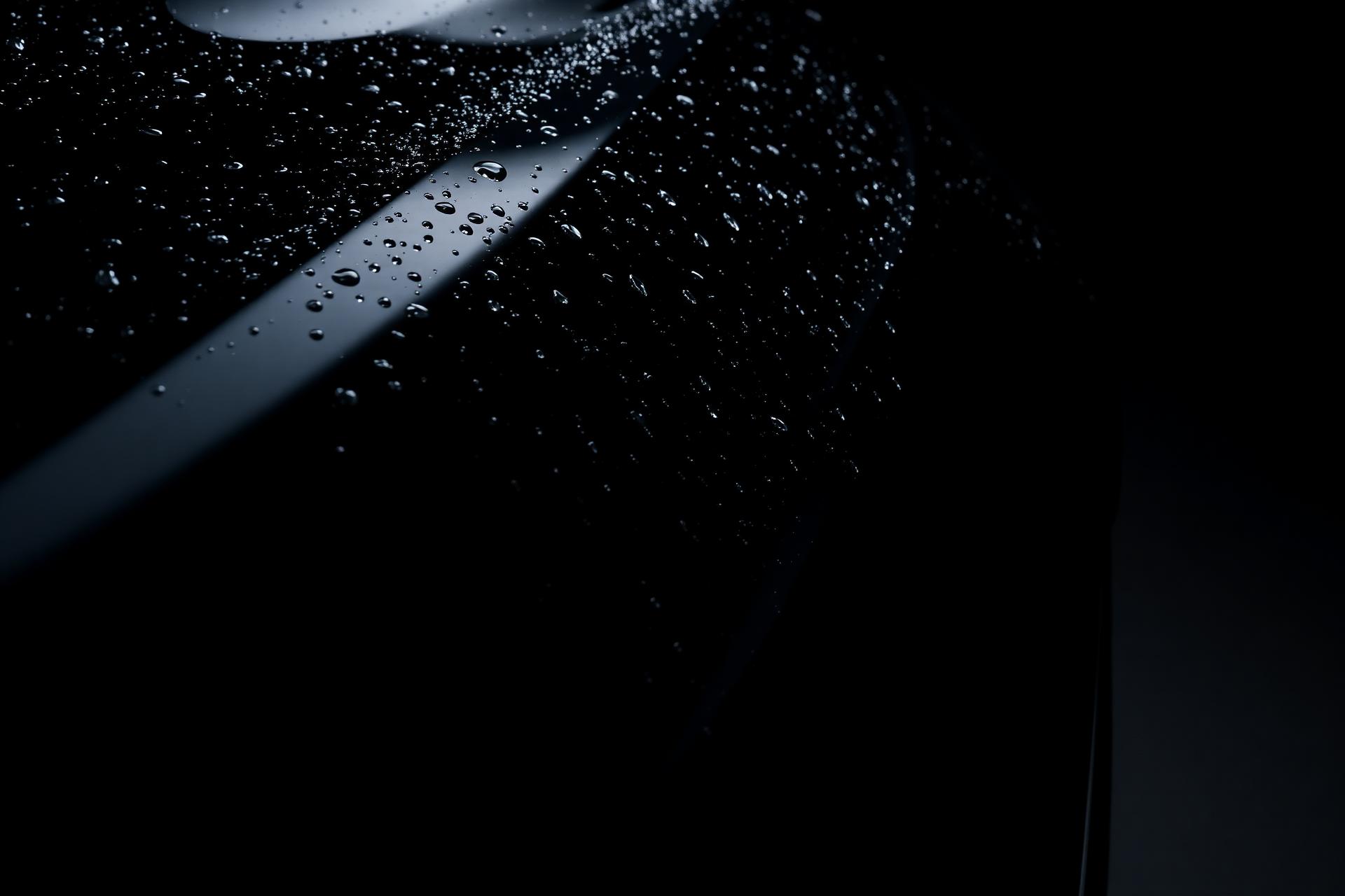 Freshly detailed black car with water beads